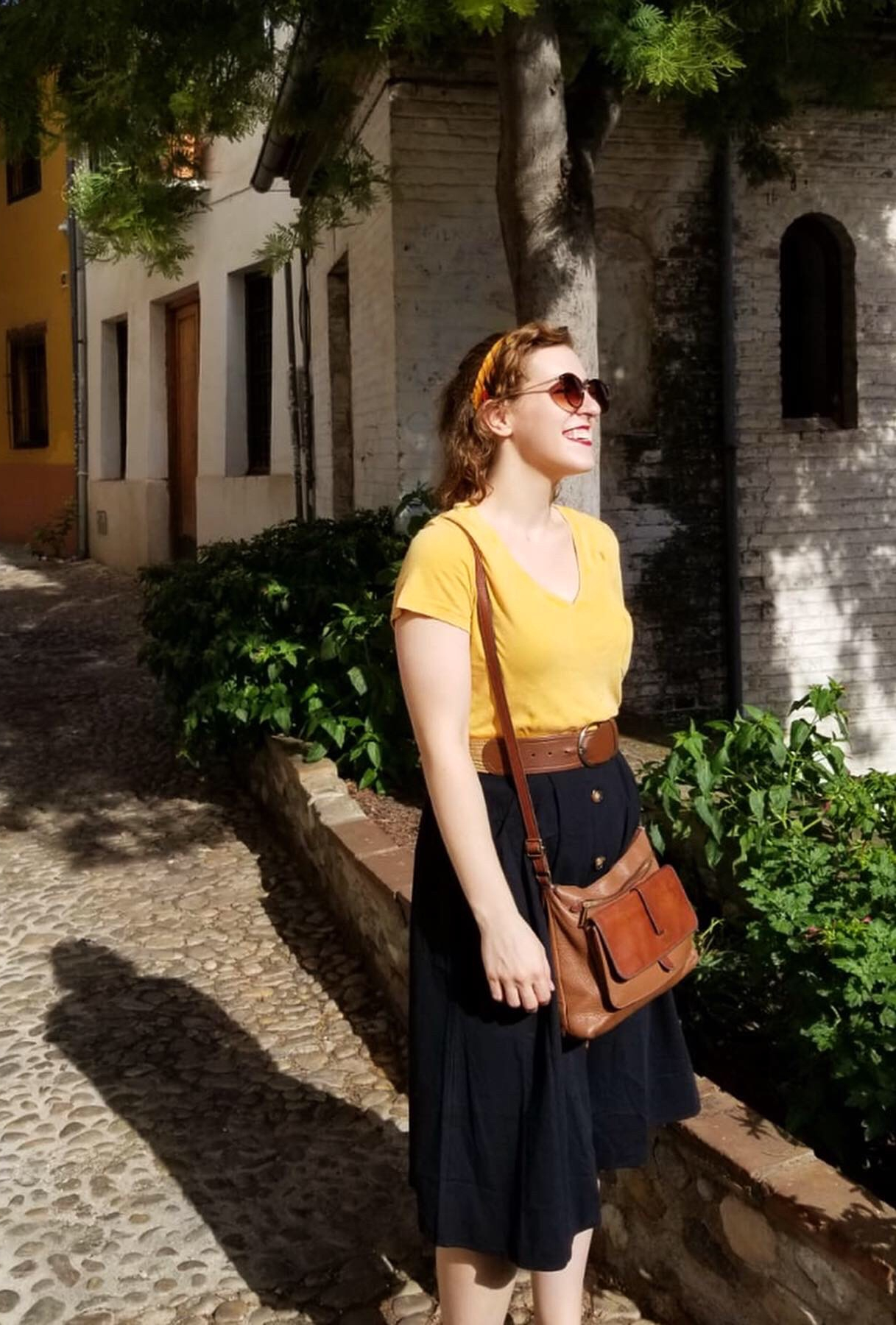 Woman standing on a bright summer alley
